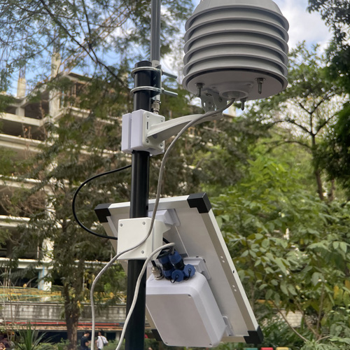 Close-up of the printed louvered Stevenson screen sensor housing alongside a solar panel and enclosure